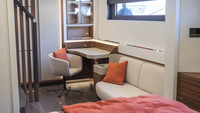 Slide: The Image of Modern interior of 2025 Fountaine Pajot Thira 80 yacht with cozy seating and desk area. - 21