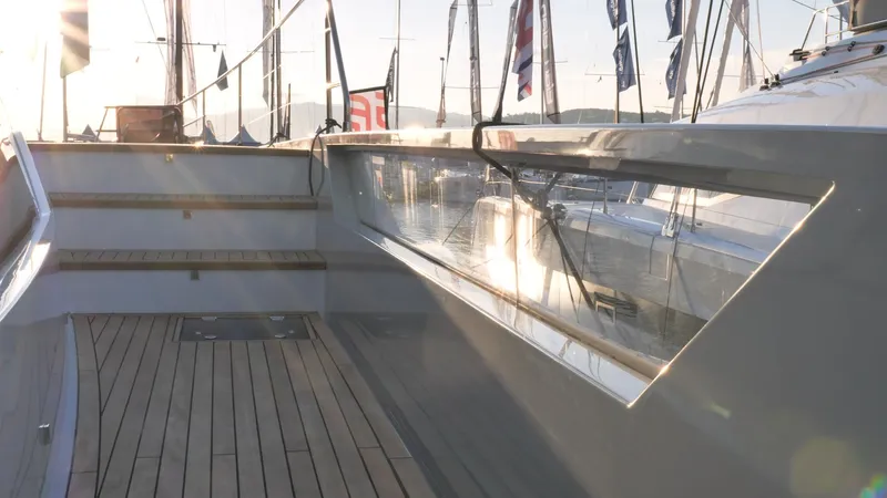 Slide: The Image of 2025 Fountaine Pajot Thira 80 yacht deck with wooden flooring and sleek design. - 9