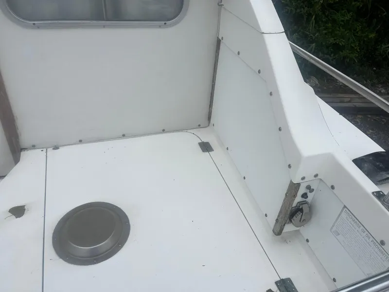 Slide: The Image of 1973 Bertram 28 Flybridge Cruiser deck, white interior, clean and spacious design. - 18