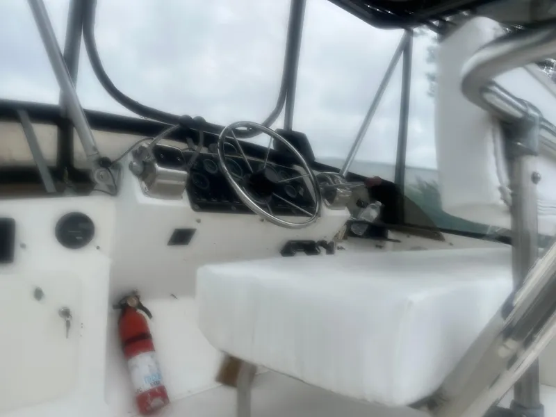 Slide: The Image of Interior of a 1973 Bertram 28 Flybridge Cruiser with steering wheel and controls. - 2