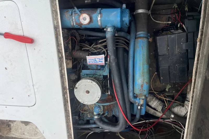 Slide: The Image of Engine compartment of a 1973 Bertram 28 Flybridge Cruiser with visible wiring and components. - 25