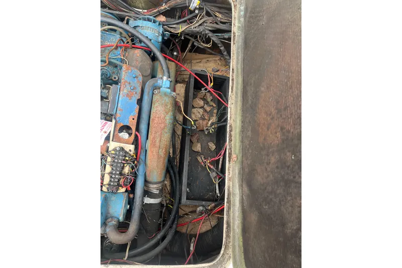Slide: The Image of Engine compartment of a 1973 Bertram 28 Flybridge Cruiser with visible wiring and components. - 32
