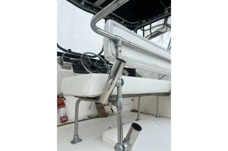 Slide: The Image of 1973 Bertram 28 Flybridge Cruiser interior with steering wheel and seating. - 34