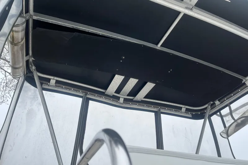 Slide: The Image of 1973 Bertram 28 Flybridge Cruiser interior roof with metal framework and black covering. - 35