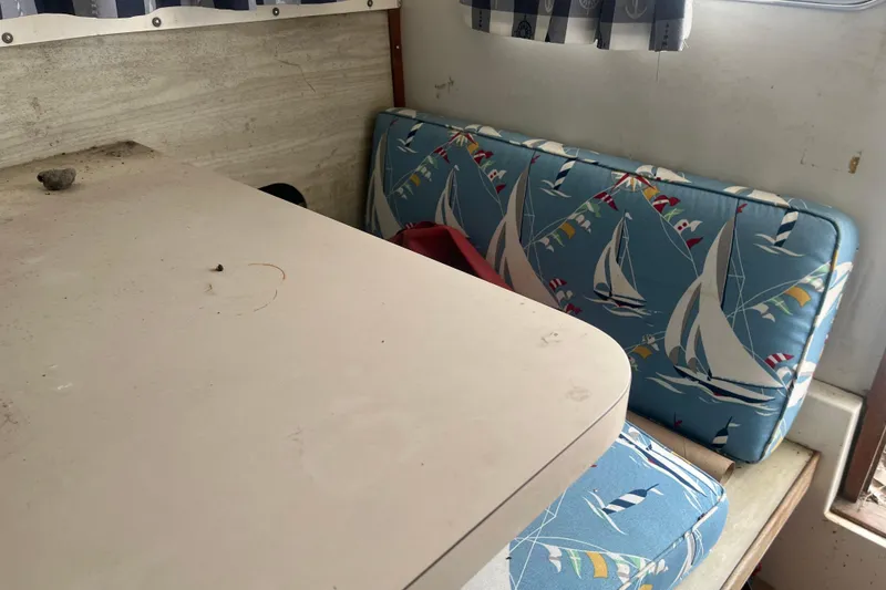 Slide: The Image of Interior of a 1973 Bertram 28 Flybridge Cruiser with nautical-themed cushions. - 39