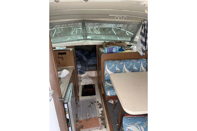 Slide: The Image of Interior of a 1973 Bertram 28 Flybridge Cruiser with nautical-themed seating and compact cabin layout. - 42