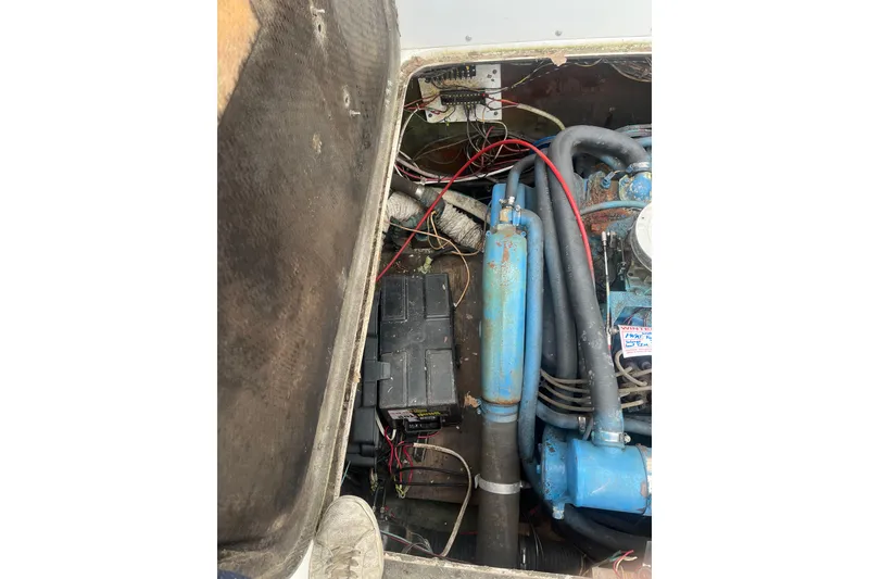 Slide: The Image of Engine compartment of a 1973 Bertram 28 Flybridge Cruiser with visible wiring and components. - 53