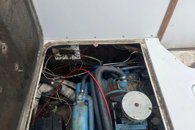 Slide: The Image of Engine compartment of a 1973 Bertram 28 Flybridge Cruiser with visible wiring and components. - 54