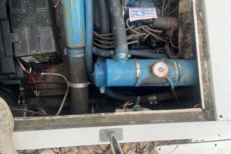 Slide: The Image of Engine compartment of a 1973 Bertram 28 Flybridge Cruiser with visible wiring and components. - 55