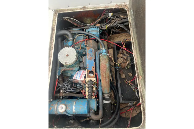 Slide: The Image of Engine compartment of a 1973 Bertram 28 Flybridge Cruiser with visible wiring and components. - 56