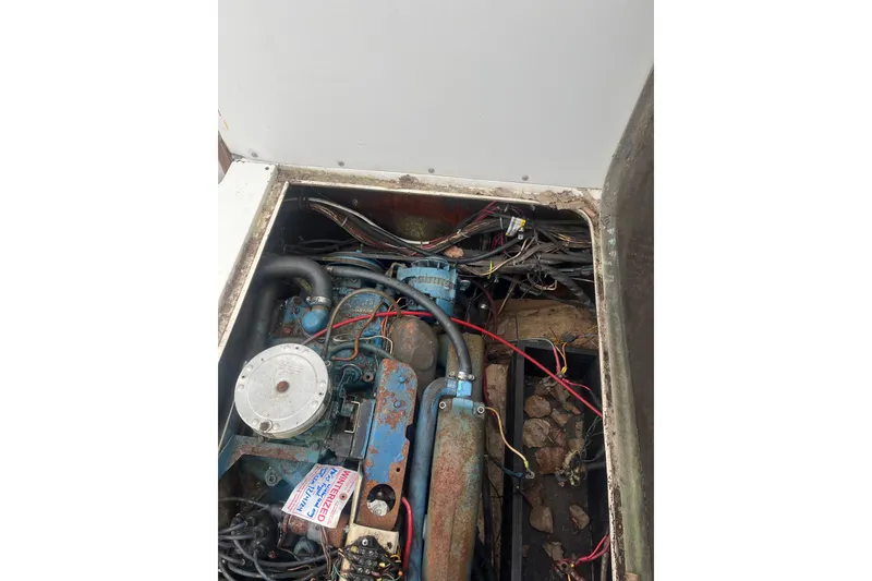 Slide: The Image of Engine compartment of a 1973 Bertram 28 Flybridge Cruiser with visible wiring and components. - 59