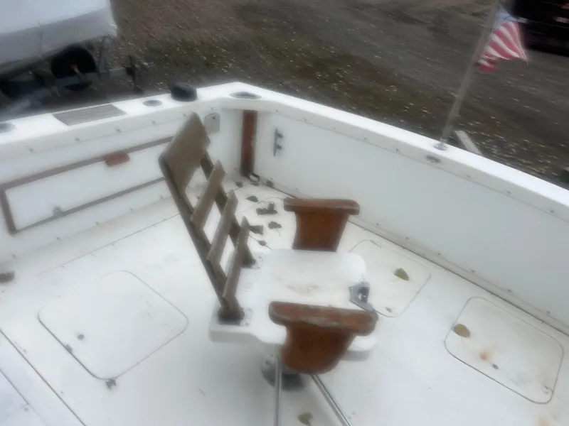 Slide: The Image of 1973 Bertram 28 Flybridge Cruiser deck with fishing chair and American flag. - 9