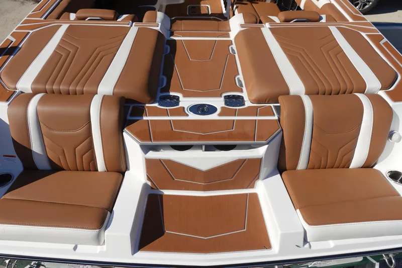 Slide: The Image of 2025 Malibu Wakesetter 25 LSV boat interior with brown and white seating. - 10