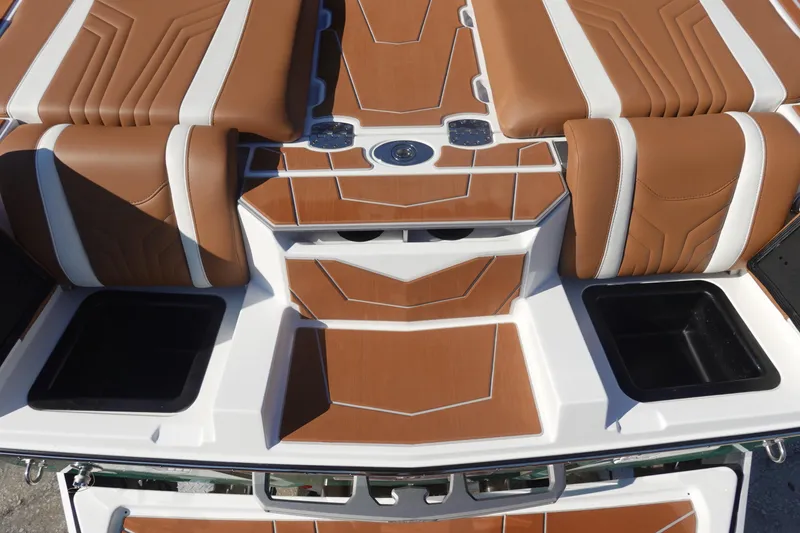 Slide: The Image of 2025 Malibu Wakesetter 25 LSV boat interior with brown and white seating and storage compartments. - 11