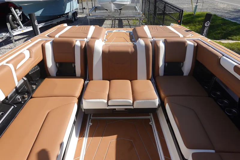 Slide: The Image of 2025 Malibu Wakesetter 25 LSV interior with luxurious brown and white seating. - 13