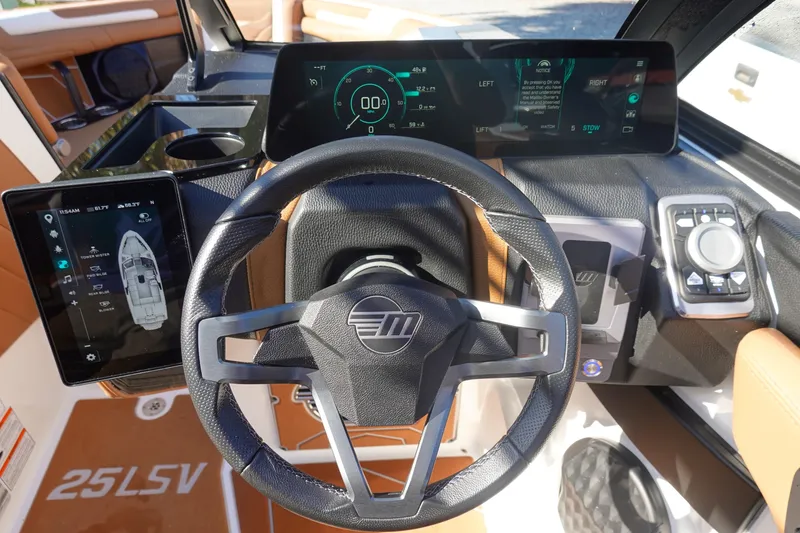 Slide: The Image of 2025 Malibu Wakesetter 25 LSV dashboard with advanced digital controls and steering wheel. - 17