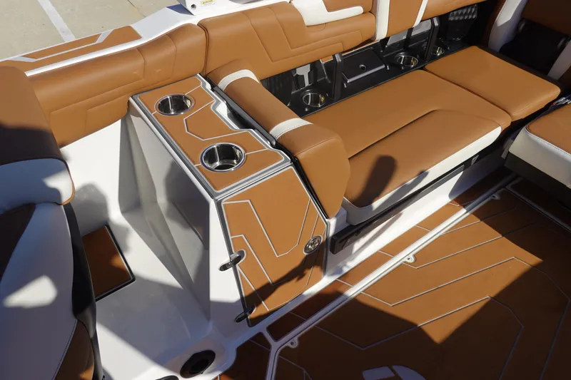 Slide: The Image of 2025 Malibu Wakesetter 25 LSV interior with brown seating and cup holders. - 23