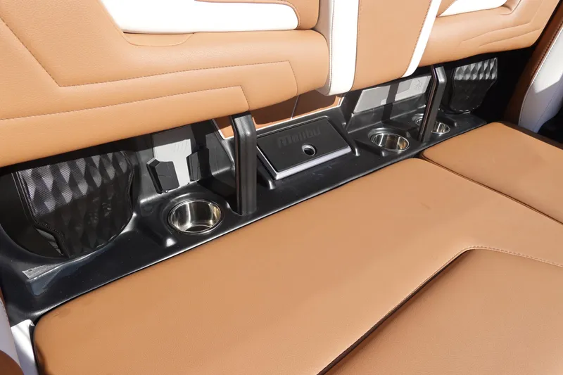 Slide: The Image of 2025 Malibu Wakesetter 25 LSV interior with tan leather seats and cup holders. - 27
