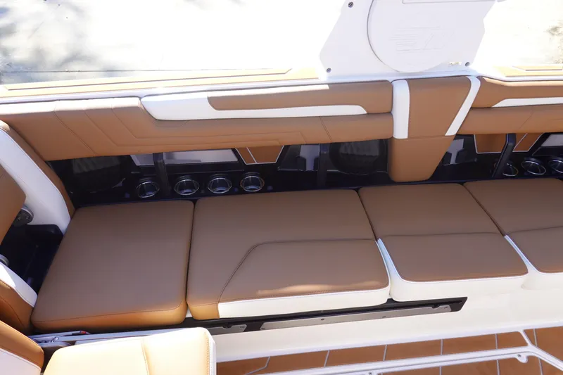 Slide: The Image of 2025 Malibu Wakesetter 25 LSV interior with tan and white cushioned seating. - 28