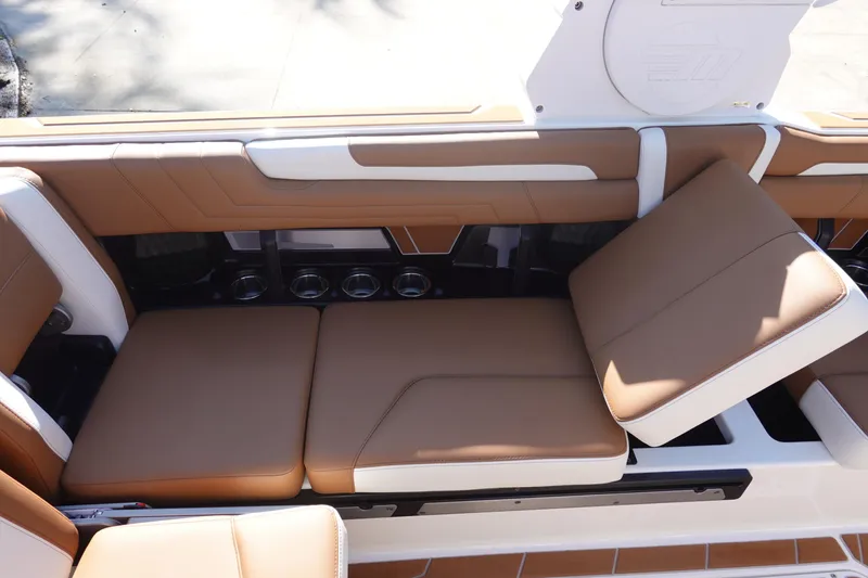 Slide: The Image of 2025 Malibu Wakesetter 25 LSV interior with tan leather seating and cup holders. - 29