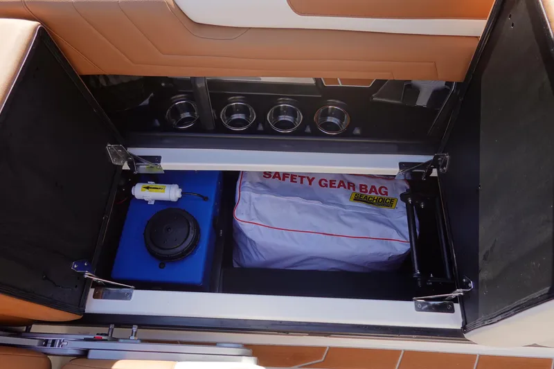 Slide: The Image of 2025 Malibu Wakesetter 25 LSV storage compartment with safety gear bag and equipment. - 30