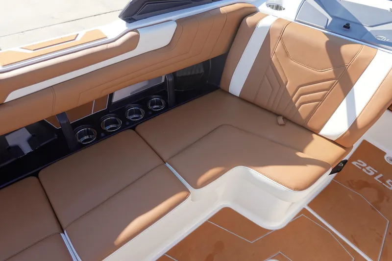 Slide: The Image of 2025 Malibu Wakesetter 25 LSV interior with tan and white seating, cup holders. - 31