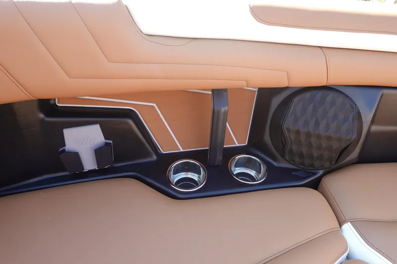 Slide: The Image of 2025 Malibu Wakesetter 25 LSV interior with tan upholstery, cup holders, and speaker. - 38