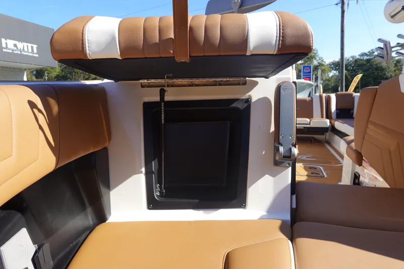 Slide: The Image of 2025 Malibu Wakesetter 25 LSV interior seating with storage compartment open. - 40