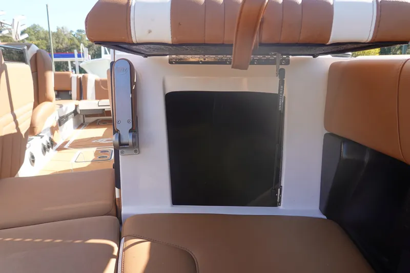 Slide: The Image of 2025 Malibu Wakesetter 25 LSV interior seating with storage compartment. - 41