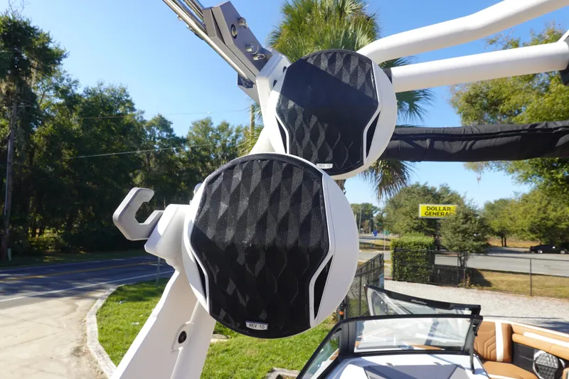 Slide: The Image of 2025 Malibu Wakesetter 25 LSV boat speakers with sleek design, outdoor setting. - 44