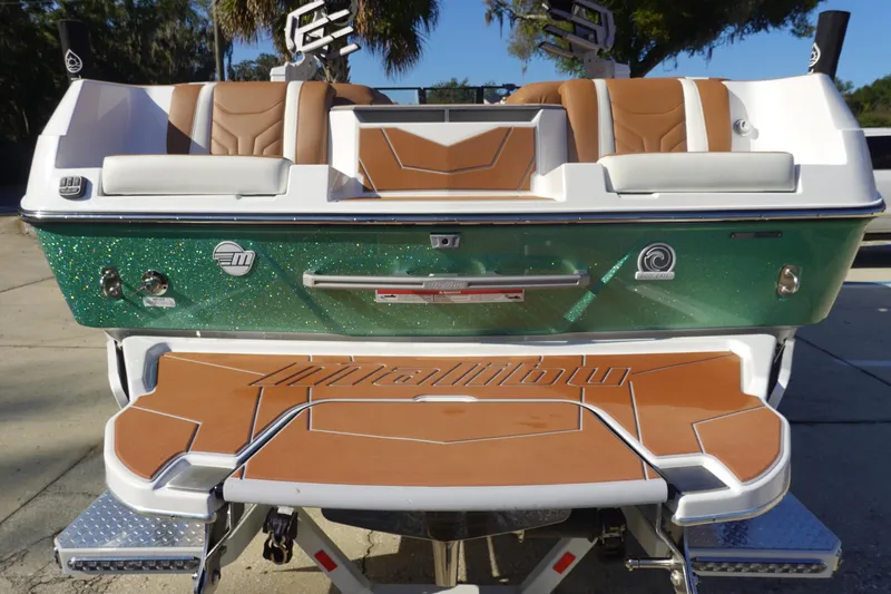 Slide: The Image of 2025 Malibu Wakesetter 25 LSV boat with green glitter finish and tan seating. - 6