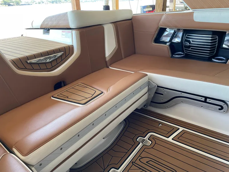 Slide: The Image of 2019 Nautique Super Air Nautique G23 Coastal Edition interior with brown and white seating. - 11