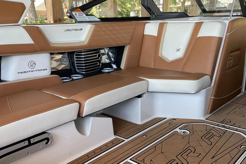 Slide: The Image of 2019 Nautique Super Air Nautique G23 Coastal Edition interior with tan and white seating. - 3