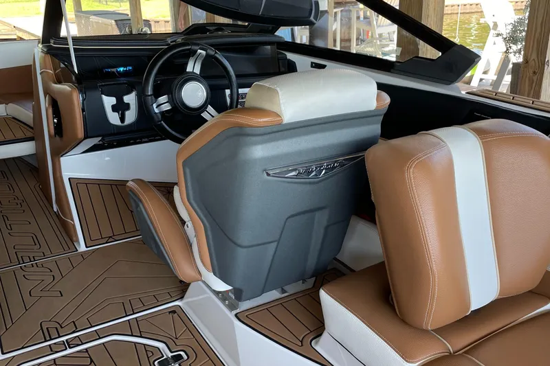 Slide: The Image of 2019 Nautique Super Air Nautique G23 Coastal Edition interior with brown and white seating. - 5