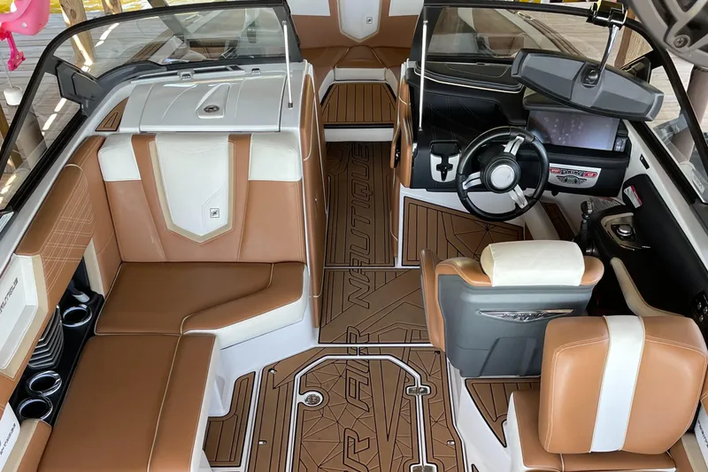 Slide: The Image of 2019 Nautique Super Air Nautique G23 Coastal Edition interior with tan and white seating. - 6