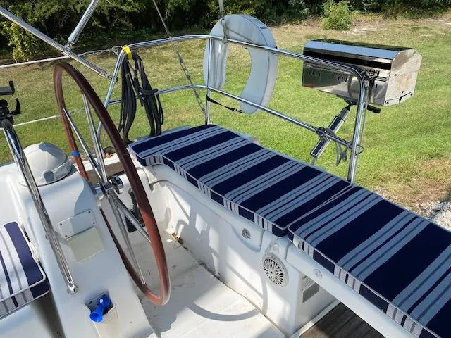 Slide: The Image of Beneteau Oceanis 40 cockpit with striped cushions, steering wheel, and grill, 2009 model. - 10