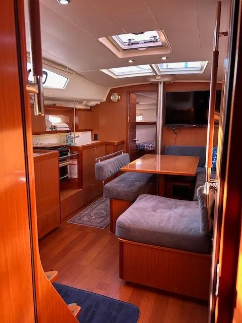 Slide: The Image of Interior of 2009 Beneteau Oceanis 40 yacht with cozy seating and modern amenities. - 14