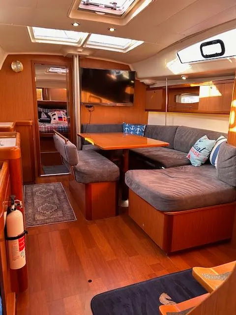Slide: The Image of Interior of 2009 Beneteau Oceanis 40 sailboat with cozy seating and modern amenities. - 15