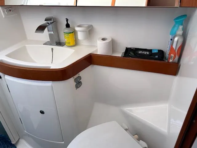 Slide: The Image of Beneteau Oceanis 40 bathroom, 2009 model, featuring sink, toilet, and cleaning supplies. - 19