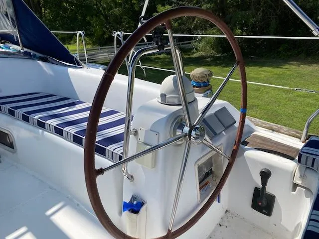 Slide: The Image of 2009 Beneteau Oceanis 40 sailboat cockpit with striped seating and steering wheel. - 5