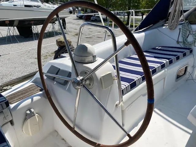 Slide: The Image of 2009 Beneteau Oceanis 40 yacht cockpit with striped seating and steering wheel. - 6