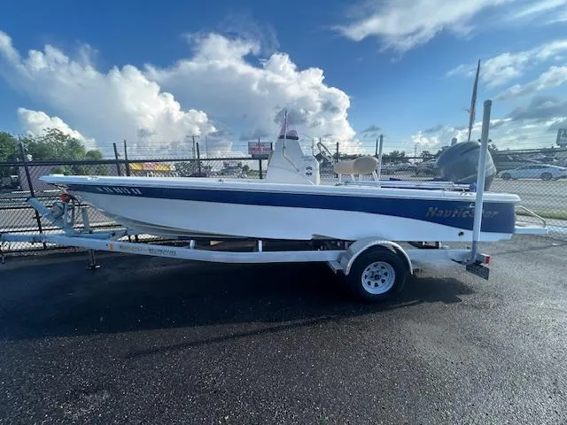 Slide: The Image of 2019 NauticStar 2140 Sport boat on trailer, parked outdoors under a cloudy sky. - 1