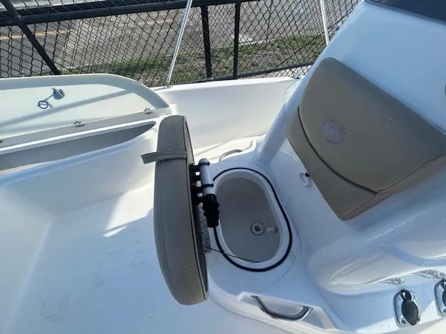 Slide: The Image of 2019 NauticStar 2140 Sport boat interior with seating and storage compartment. - 12