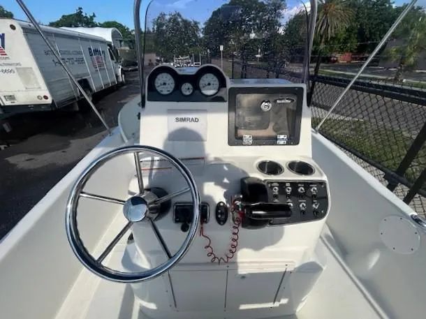 Slide: The Image of 2019 NauticStar 2140 Sport boat console with steering wheel and navigation controls. - 13