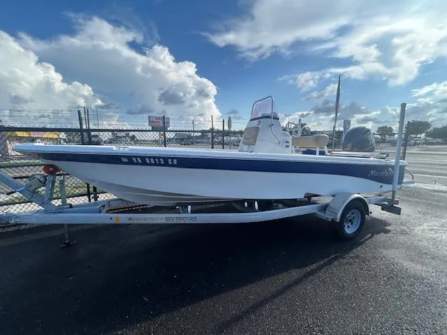 Slide: The Image of 2019 NauticStar 2140 Sport boat on trailer under cloudy sky. - 2