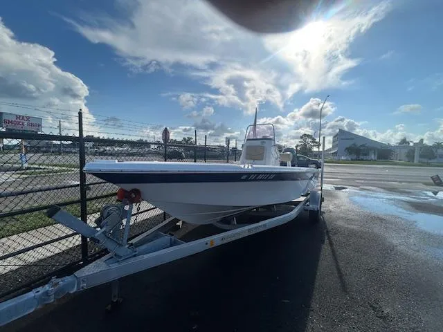 Slide: The Image of 2019 NauticStar 2140 Sport boat on trailer under sunny sky. - 3
