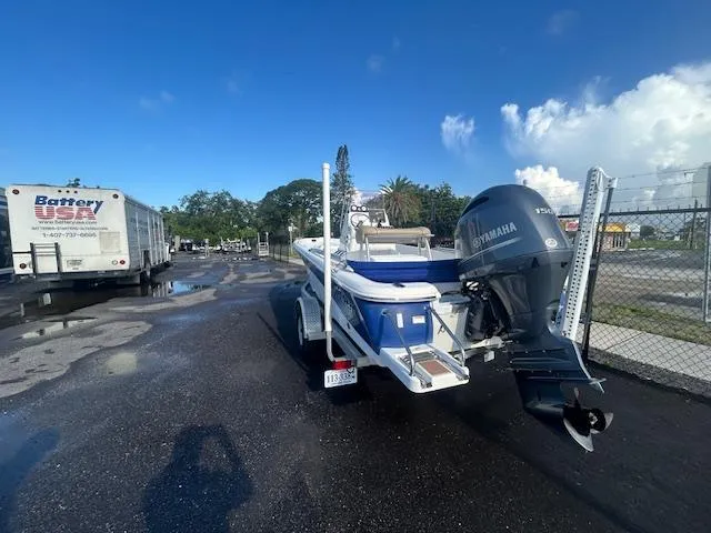 Slide: The Image of 2019 NauticStar 2140 Sport boat on trailer with Yamaha engine, parked near Battery USA truck. - 5
