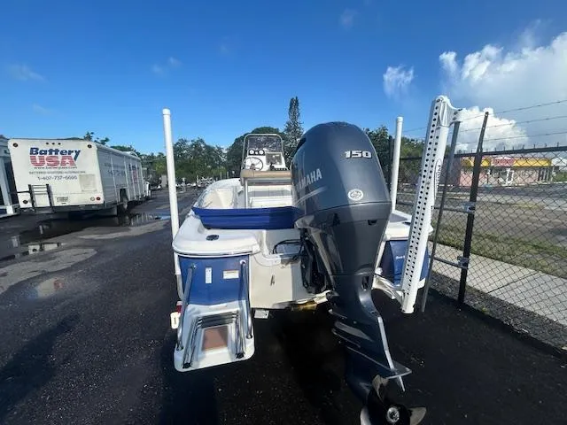 Slide: The Image of 2019 NauticStar 2140 Sport boat with Yamaha 150 engine, parked outdoors. - 6