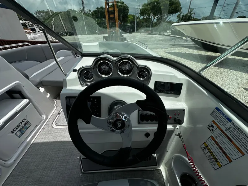Slide: The Image of 2024 NauticStar 203 DC boat dashboard with steering wheel and gauges. - 10