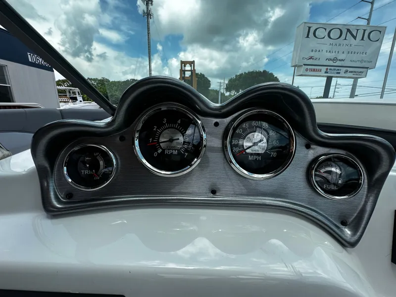 Slide: The Image of Dashboard of 2024 NauticStar 203 DC boat with gauges for RPM, speed, and fuel. - 12